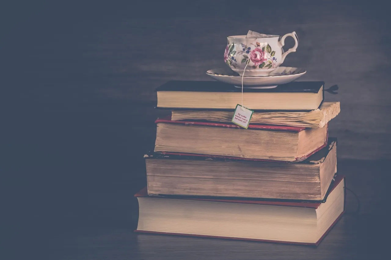 A teacup on top of a stack of old books